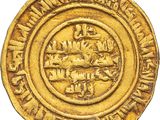 a close up of a gold coin with a medallion on it