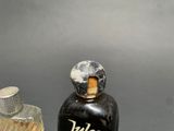 a small bottle of liquor next to a small bottle of liquor