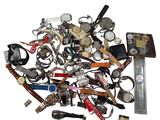 a pile of assorted watches on a white surface