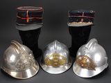 four different types of helmets are lined up on a black surface