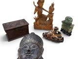 a group of statues and a box on a white surface