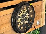 a clock that is on the side of a wooden box