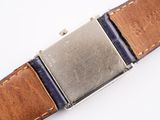 a close up of a watch on a white surface