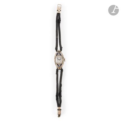 a close up of a watch on a white surface with a white background