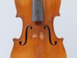 an old violin sitting on a stand against a white background