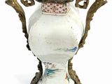 a white vase with a red and blue design on it