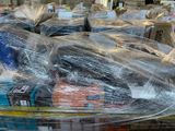 many boxes of food wrapped in plastic on a table
