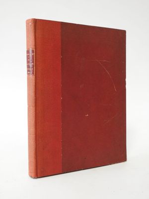 a red book sitting on top of a white surface