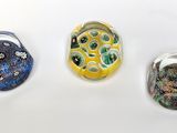 three different colored rings sitting on top of a white surface