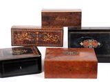 three wooden boxes with decorative designs on them sitting next to each other