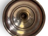 a close up of a metal object on a white surface