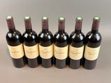 six bottles of wine are lined up in a row