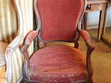 a red chair that is sitting next to a brown chair