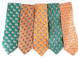 several different colored ties are arranged in a row on a white surface