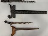 trois types d'armes différents sont exposés sur une surface blanche