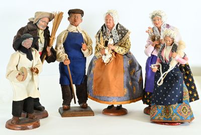 five figurines of people dressed in traditional clothing