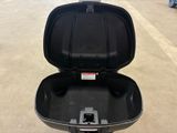 a black suitcase that is open on the ground