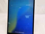 a close up of a tablet on a white surface with a blue screen