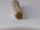 a close up of a wooden stick on a white surface