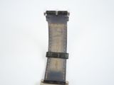 a close up of a watch on a white surface