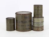several old tins of different sizes and colors are stacked on top of each other