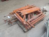 a pile of wood sitting on the ground next to a pile of other wood