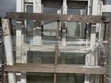 a lot of windows that are sitting on a pallet