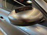 a close up of a car ' s side mirror with a sticker on it