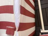 a red and white striped bag hanging on a rack