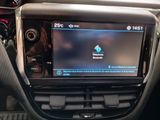 the interior of a car with a touch screen and a steering control