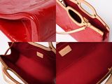a close up of a red purse with a gold handle