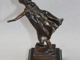 statue of a woman in a dress on a marble base