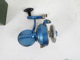 a blue spinning reel on a white table