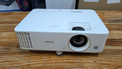 un projecteur blanc posé sur une table en bois