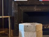 a stone block sitting on the floor in front of a fire place