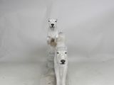 statue of two polar bears sitting on a stone block