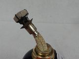 a black bottle with a rope on top of it