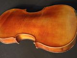 an old violin sits on a black surface