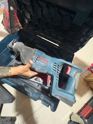 a man that is working on a tool in the garage