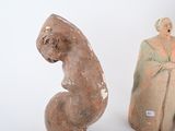three clay figurines of a woman and a man on a white background