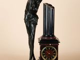 statue of a woman leaning on a clock with a clock in front of her
