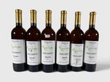 six bouteilles de vin sont alignées sur une surface blanche