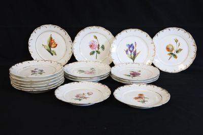 a lot of plates with flowers on them on a table