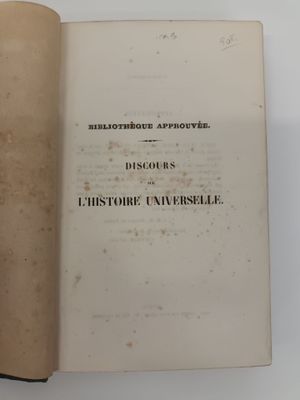 a book open on a white surface with a black border