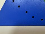 a close up of a triangle shaped object with holes in it