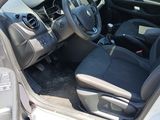 the interior of a car with the door open and the driver ' s seat down