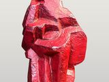 statue of a man holding a guitar in a red color