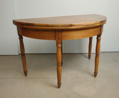 a small wooden table with a curved top on the floor