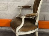 a chair that is sitting in front of a brick wall