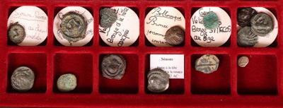 many coins in a red box with writing on them